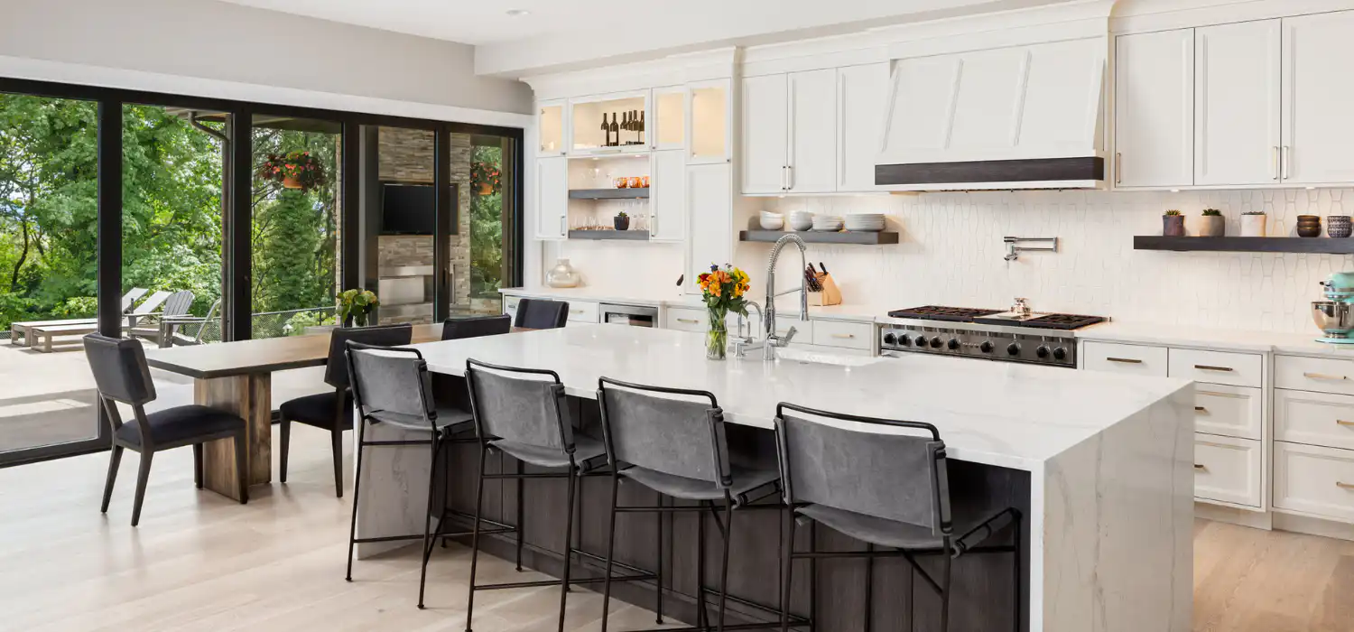 Open-concept kitchen with spotless island after thorough home cleaning service.